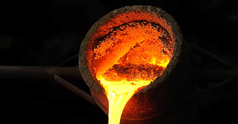 a crucible pouring out molten metal