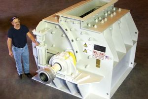 White Williams industrial pulverizer with engineer standing beside